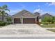 Charming single-story home featuring a three-car garage, mature landscaping, and a brick-paved driveway at 12398 Keyridge Loop, Largo, FL 33778