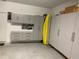 Well-organized garage featuring storage cabinets and a workbench with tool storage at 12398 Keyridge Loop, Largo, FL 33778