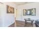 Hallway area with a lion painting, modern paintings, glass-topped table with an animal figurine at 12398 Keyridge Loop, Largo, FL 33778
