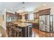 Gourmet kitchen featuring stainless steel appliances, granite countertops, and center island with seating at 12398 Keyridge Loop, Largo, FL 33778