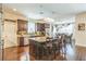Open concept kitchen offers large island, granite counters, stainless appliances and hardwood flooring at 12398 Keyridge Loop, Largo, FL 33778