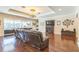 Spacious living room featuring hardwood floors, a fireplace, and seamless indoor-outdoor flow at 12398 Keyridge Loop, Largo, FL 33778