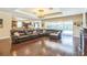Spacious living room featuring hardwood floors, a chandelier, and seamless indoor-outdoor flow at 12398 Keyridge Loop, Largo, FL 33778