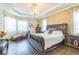 Luxurious main bedroom features hardwood floors, large windows, and a decorative chandelier at 12398 Keyridge Loop, Largo, FL 33778