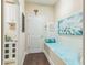 Mudroom area with storage cabinets and a bench seat displaying decorative pillows and artwork at 12398 Keyridge Loop, Largo, FL 33778