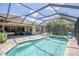 Screened-in pool and outdoor area with lounge chairs and beautiful blue sky views at 12398 Keyridge Loop, Largo, FL 33778