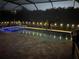 The property's pool and jacuzzi are lit with blue lights providing nighttime relaxation at 12398 Keyridge Loop, Largo, FL 33778
