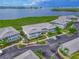 Aerial view showcases the condo community near lush greenery and a body of water at 1319 Perico Point Cir, Bradenton, FL 34209
