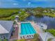 Aerial view of a pool overlooking a pond and lush landscaping at 1319 Perico Point Cir, Bradenton, FL 34209