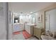 Bathroom featuring double sinks, granite countertops, decorative accents, and natural lighting at 1319 Perico Point Cir, Bradenton, FL 34209