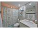 Bright bathroom features a shower with nautical themed curtain, single vanity, and coastal decor on the shelves at 1319 Perico Point Cir, Bradenton, FL 34209