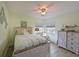 Cozy bedroom with a queen-sized bed, ceiling fan, natural light, and decorative nautical accents creating a serene space at 1319 Perico Point Cir, Bradenton, FL 34209