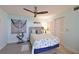 Bright bedroom with coastal decor, ceiling fan, and a comfortable queen-sized bed with nautical accents at 1319 Perico Point Cir, Bradenton, FL 34209