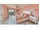 Cozy bedroom with sliding glass doors to balcony, tile floors, and a ceiling fan at 1319 Perico Point Cir, Bradenton, FL 34209