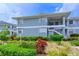 Well-maintained condo building surrounded by lush landscaping with exterior staircases and covered entryways at 1319 Perico Point Cir, Bradenton, FL 34209