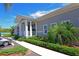 Community clubhouse featuring a covered entrance, white columns, and lush landscaping at 1319 Perico Point Cir, Bradenton, FL 34209