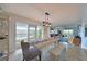 Dining area featuring a wooden table and an open concept to the living room and water views at 1319 Perico Point Cir, Bradenton, FL 34209