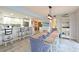 Open concept dining room features a rustic wooden table and flows into the kitchen at 1319 Perico Point Cir, Bradenton, FL 34209