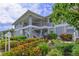 Condo exterior features nicely landscaped grounds and a light blue facade with white railings and shutters at 1319 Perico Point Cir, Bradenton, FL 34209