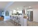 Bright kitchen features white cabinets, stainless steel appliances, and a breakfast bar with stylish stools at 1319 Perico Point Cir, Bradenton, FL 34209