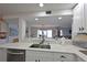 Bright kitchen with stainless steel dishwasher and sink with a view into the living area at 1319 Perico Point Cir, Bradenton, FL 34209