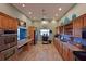 A large kitchen with light green walls and wooden cabinets and stainless steel appliances at 1319 Perico Point Cir, Bradenton, FL 34209