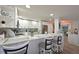Open concept kitchen with white cabinetry, stone countertops, recessed lighting and barstool seating at 1319 Perico Point Cir, Bradenton, FL 34209