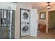 Convenient laundry closet with stacked washer and dryer located adjacent to the kitchen and dining area at 1319 Perico Point Cir, Bradenton, FL 34209