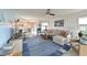Spacious living room with comfortable seating and view into the dining area and screened in lanai at 1319 Perico Point Cir, Bradenton, FL 34209