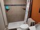 Small bathroom featuring a shower, tiled walls, and a toilet at 1423 17Th E Ave, Bradenton, FL 34208