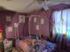 Bedroom featuring a bed frame, purple walls, and a ceiling fan at 1423 17Th E Ave, Bradenton, FL 34208