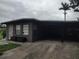 Exterior view of a single-story home with an attached carport at 1423 17Th E Ave, Bradenton, FL 34208