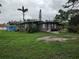 Charming home with a spacious front yard, mature trees, and lush landscaping at 1423 17Th E Ave, Bradenton, FL 34208