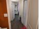 Hallway with white doors, wood floors, and neutral walls at 1423 17Th E Ave, Bradenton, FL 34208