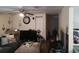 A cozy living room featuring a ceiling fan, a large TV and plentiful decor at 1423 17Th E Ave, Bradenton, FL 34208