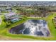 Gorgeous aerial view showing a pool, home, and pond at 15815 Tradewind Ter, Bradenton, FL 34211