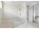 Modern shower with pebble floor and glass doors next to the entrance at 15815 Tradewind Ter, Bradenton, FL 34211