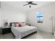 Bright bedroom featuring a comfortable queen bed, a nightstand, and a window bringing in natural light at 15815 Tradewind Ter, Bradenton, FL 34211