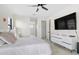 Spacious bedroom with a ceiling fan, tile floors, and a large TV above a modern dresser at 15815 Tradewind Ter, Bradenton, FL 34211