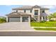 Charming two-story home boasts a three-car garage, beautiful landscaping, and inviting entryway at 15815 Tradewind Ter, Bradenton, FL 34211