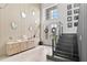 Welcoming foyer with natural light, contemporary design, and stylish decor elements, and an adjacent staircase at 15815 Tradewind Ter, Bradenton, FL 34211