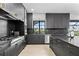 Modern kitchen with sleek dark cabinetry, chef-grade stainless steel appliances, and expansive countertops at 15815 Tradewind Ter, Bradenton, FL 34211
