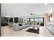 Spacious living room featuring an oversized gray couch, sleek black accents, and views to the outdoors at 15815 Tradewind Ter, Bradenton, FL 34211