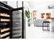 A close-up shot of a stylish wine fridge, offering a glimpse into the elegant living room space at 15815 Tradewind Ter, Bradenton, FL 34211