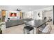 Open-concept space integrates living and dining areas with stylish furniture and views of playful ' corner at 15815 Tradewind Ter, Bradenton, FL 34211