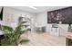 Bright home office with modern desk, shelving, and large windows offering ample natural light at 15815 Tradewind Ter, Bradenton, FL 34211