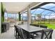 Spacious outdoor patio with a complete kitchen, and dining area overlooks the yard and pool at 15815 Tradewind Ter, Bradenton, FL 34211