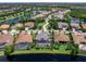 Stunning aerial view of a home with screened-in pool and lake access in a beautiful, landscaped community at 16628 Berwick Ter, Lakewood Ranch, FL 34202