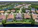 Stunning aerial view of a home with screened-in pool and lake access in a beautiful, landscaped community at 16628 Berwick Ter, Lakewood Ranch, FL 34202
