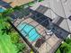 Aerial view of the private screened-in pool and patio area, surrounded by lush landscaping and manicured grounds at 16628 Berwick Ter, Lakewood Ranch, FL 34202